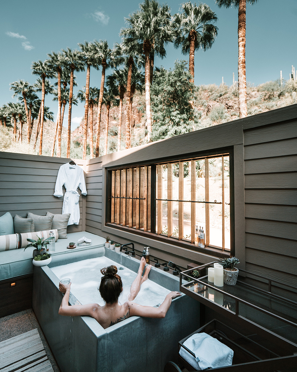 Woman enjoying exposed outdoor tub in palm springs Cailfornia